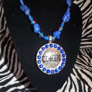 Blue bead necklace a cowgirl pendant